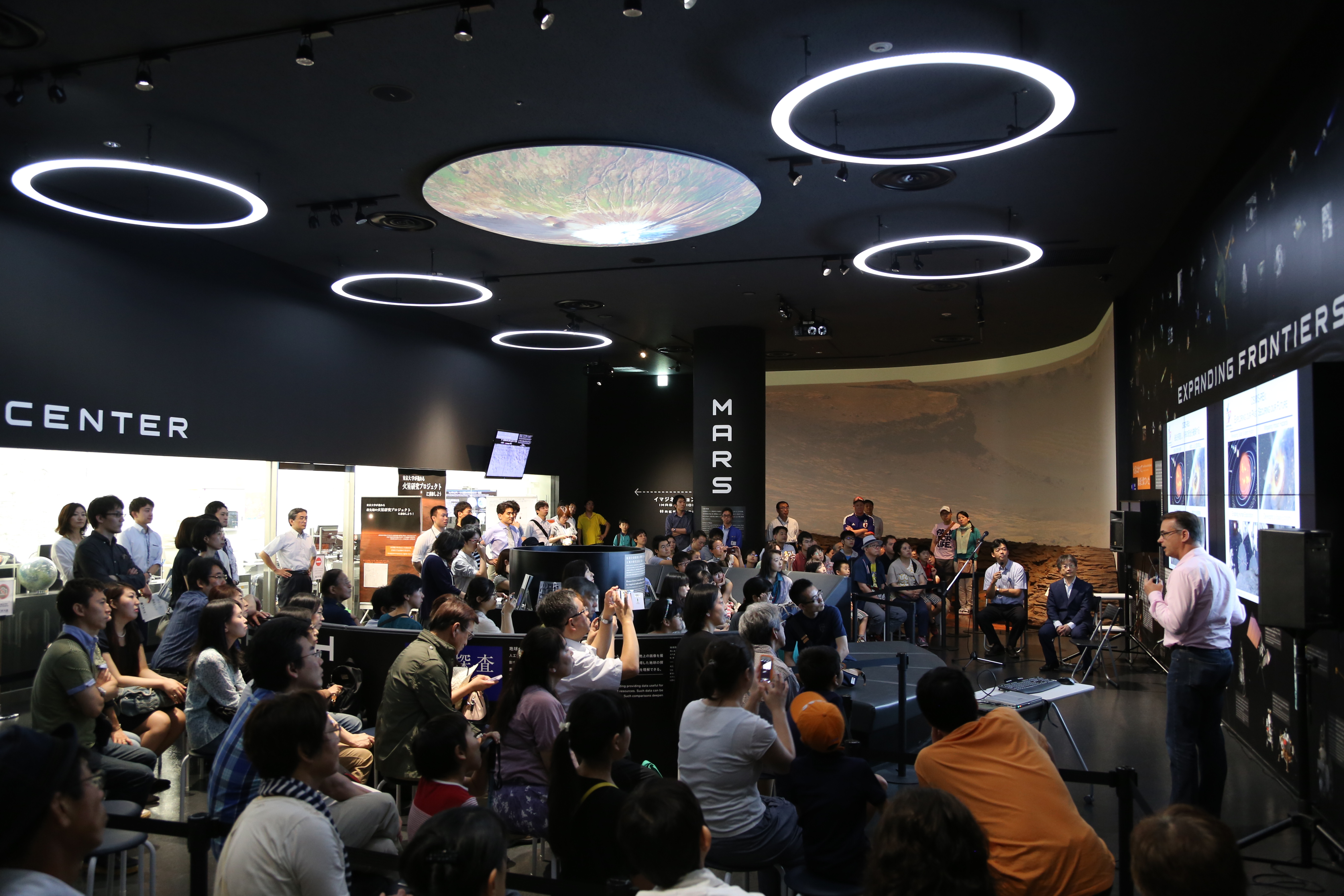 The UA's Dante Lauretta , OSIRIS-REx principal investigator, gives a presentation to more than 200 members of the public at the TenQ Space Museum in Tokyo, explaining the collaborative efforts between the OSIRIS-REx and Hayabusa 2 asteroid sample return m The UA's Dante Lauretta , OSIRIS-REx principal investigator, gives a presentation to more than 200 members of the public at the TenQ Space Museum in Tokyo, explaining the collaborative efforts between the OSIRIS-REx and Hayabusa 2 asteroid sample return m